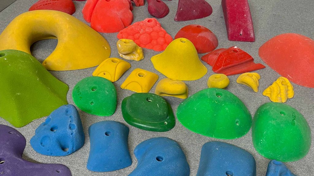 Climbing holds arranged to form a rainbow